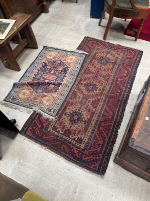 a cat that is sitting on a rug in the middle of a room