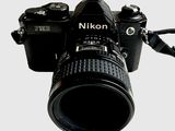 a camera with a lens attached to it ' s body