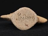 a close up of a stone ring with a small inscription on it