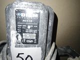 a dirty parking meter sitting in the corner of a room