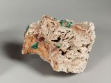 a piece of rock that has green sprinkles on it