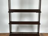 a wooden book shelf with three shelves on top of it