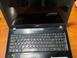 a laptop that is open on a wooden table