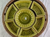 a wicker basket with a green and yellow plate in it