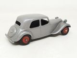 a silver toy car with red wheels on a white surface
