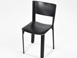 a black chair that is sitting on a white surface