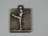 a picture of a silver charm with a ballerina on it