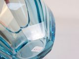 a blue glass vase with a sticker on it