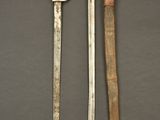 two knives are sitting next to each other on a table