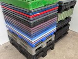 a lot of different colored plastic pallets stacked on top of each other