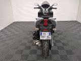 a motorcycle that is parked in a room with a checkered floor