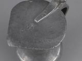 a close up of a metal object on a white surface