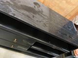 a black desk with a drawer underneath it