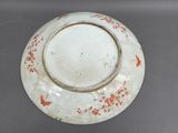 a white plate with red flowers on it on a table