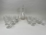a lot of wine glasses and a decanter on the table
