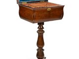 an old wooden table with a blue velvet covered top and a wooden stand