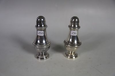 two silver salt and pepper shakers on a white surface