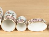 five cups sitting next to each other on a table