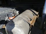 a can of oil sitting on the back of a truck