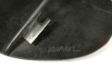 a metal object that is on a white surface
