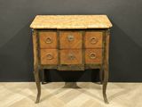 an antique chest of drawers with a marble top