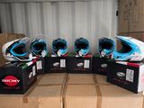 several boxes of helmets are stacked on top of each other