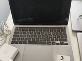 a laptop computer sitting on top of a desk with a charger