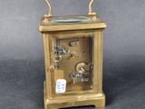 a gold clock that is sitting on a table