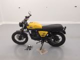 a yellow and black motorcycle parked in a white room