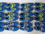 many pairs of blue and yellow tennis shoes on a table