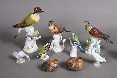 many figurines of birds sitting on top of each other