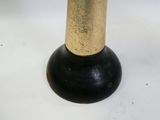 a black and gold vase on a white table