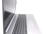 a silver laptop computer sitting on top of a white table