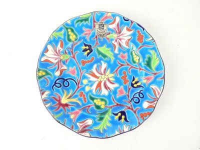 a blue plate with a floral design on it