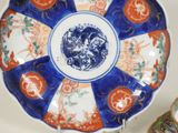 a blue and orange plate with a dragon on it