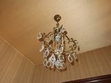 a crystal chandelier hanging from the ceiling in a room