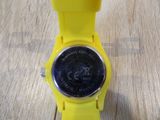 a yellow watch with a black face on a wooden table