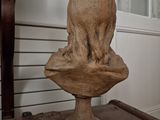 a statue of an elephant on a pedestal in a room
