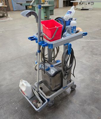 a small cart with a bucket on it in a warehouse