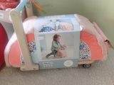 a small child ' s bed with a doll in it