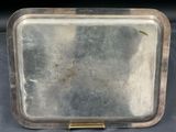 a silver tray with a handle on it on a table