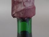 a bottle of wine that has a piece of paper on top of it