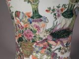 a vase that has flowers and birds on it