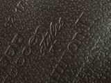 the inside of a black leather bag with writing on it