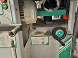 an image of a machine that is working on a piece of wood
