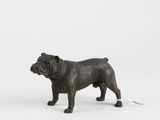 a small statue of a dog standing next to a computer mouse