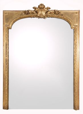 an ornate gold mirror with a white background and a gold frame