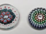 two glass magnets that are sitting on a table