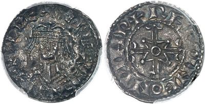 a close up of a coin with a cross on it