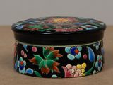 a black box with colorful flowers on it on a table
